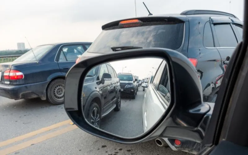 Car wing mirror showing traffic jam 