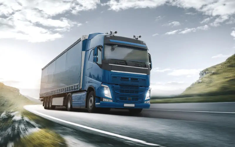 Large heavy goods vehicle driving on an open road