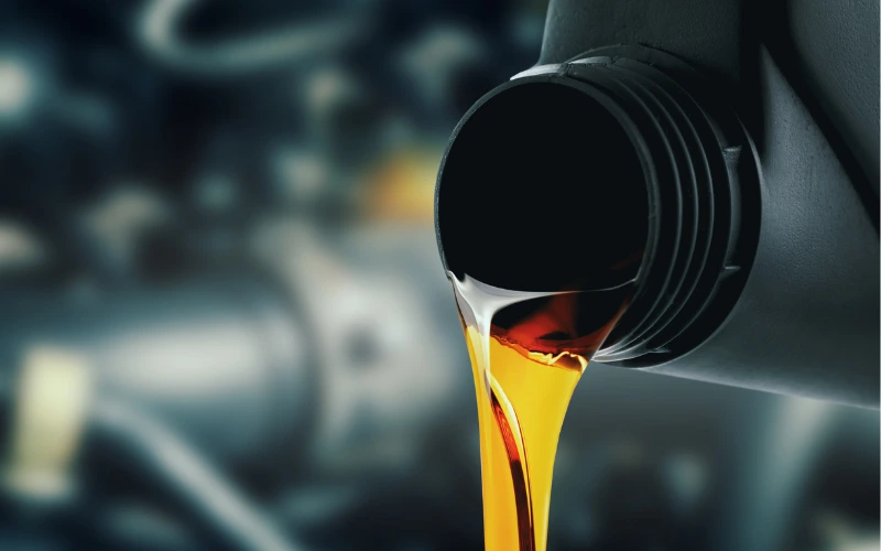 Engine oil being poured into the reservoir.