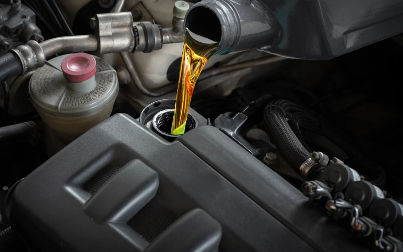 Lubricant being poured into reservoir.
