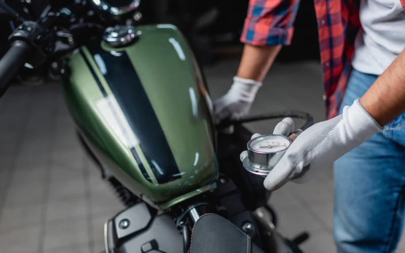 Checking tyre pressure on a motorbike