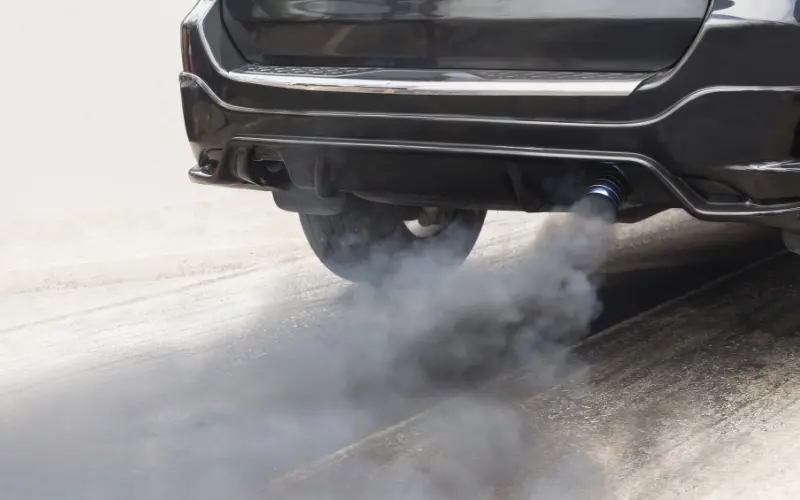 Grey smoke from car exhaust.