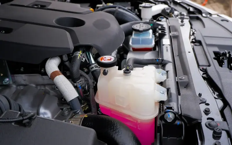 Image of coolant tank under the bonnet of a vehicle.