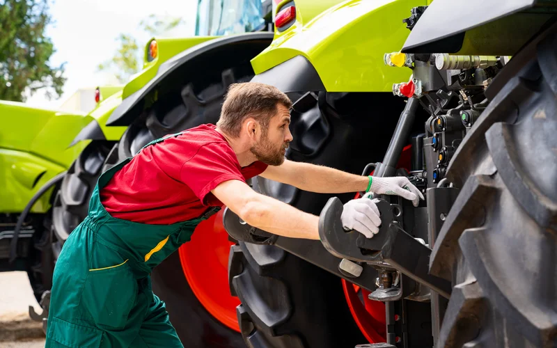 Mechanic doing checks on tractor.