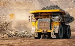 Yellow truck driving through an open-pit mine thumbnail 