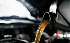 Engine oil being poured into the reservoir.