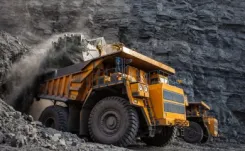 Yellow off-road dump truck off-loading rubble