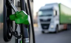 Close up of fuel pump with truck in the background.